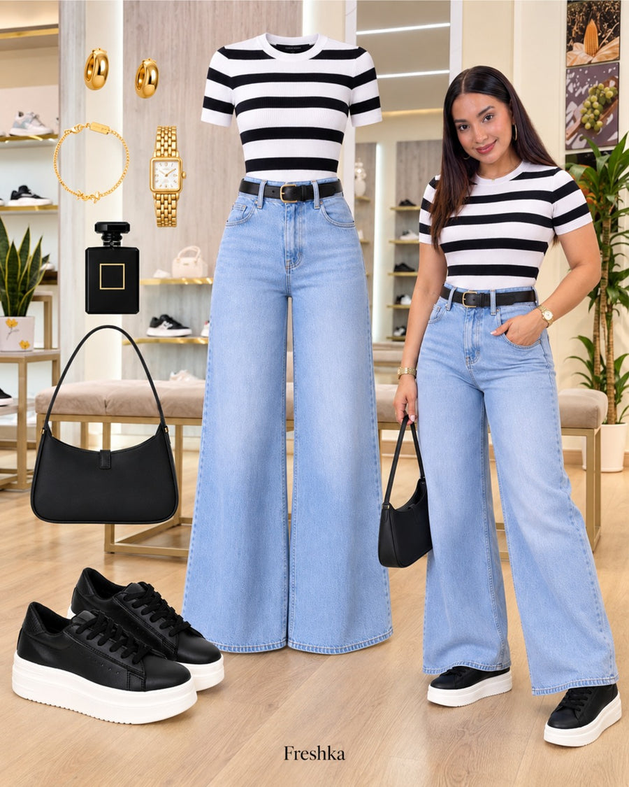 Look con tenis Oreo: camiseta de rayas negras y blancas con jeans claros anchos.