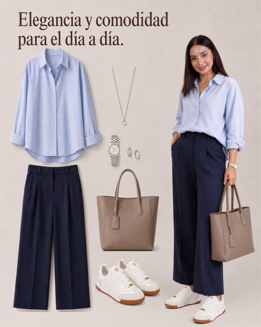 Tenis Lux White con camisa celeste, pantalón azul marino amplio y bolso taupe.