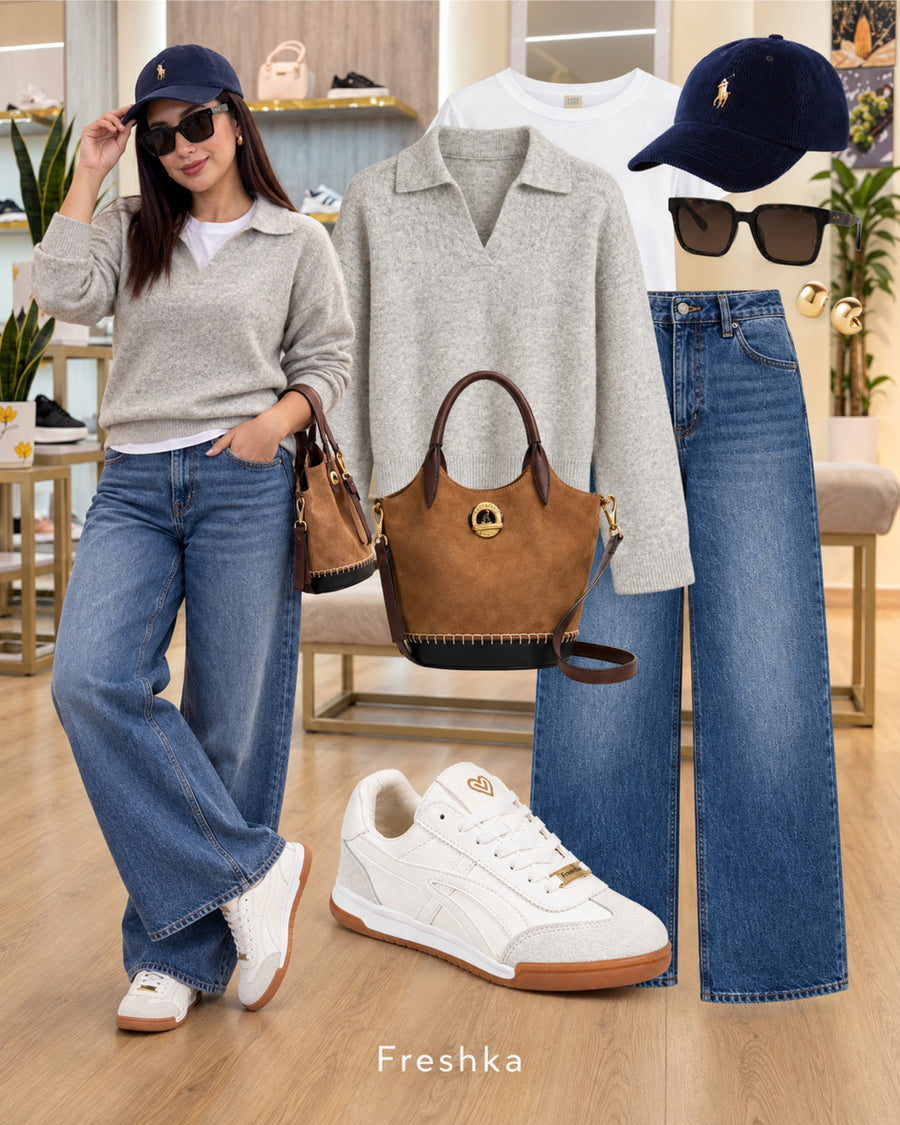 Tenis Lux White con polo gris, jeans amplios y gorra azul marino en un look casual.