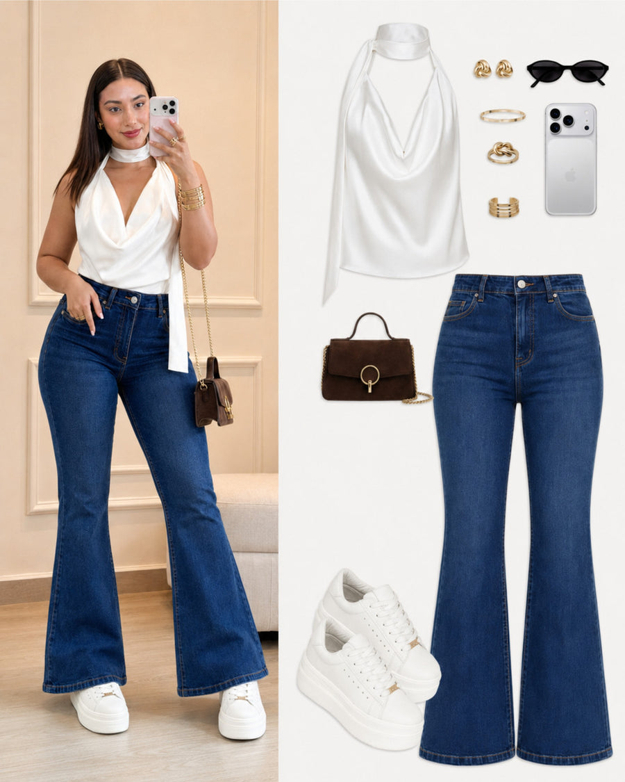 Idea de look con tenis Vainilla: blusa blanca halter y jeans oscuros acampanados.